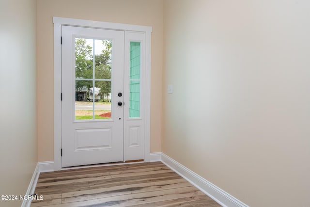 doorway to outside featuring light wood-style floors and baseboards