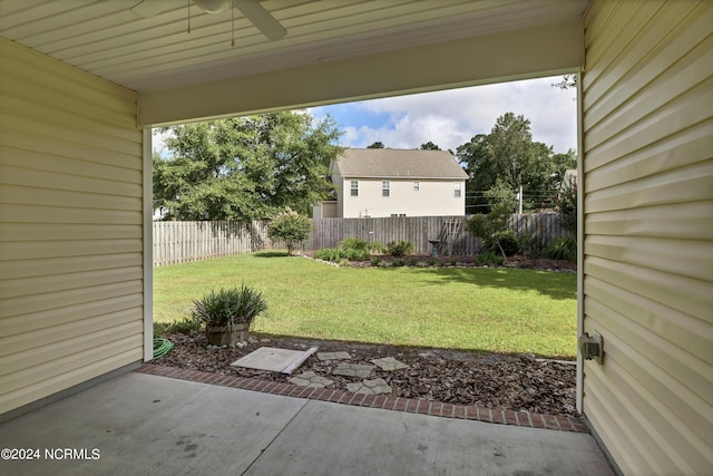 view of yard featuring a ceiling fan, a fenced backyard, and a patio