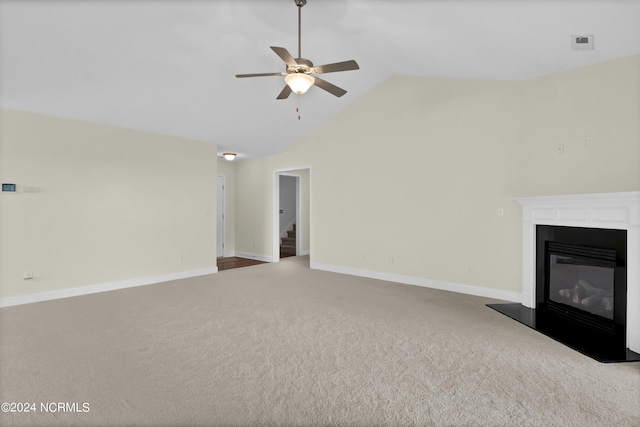 unfurnished living room with visible vents, baseboards, a ceiling fan, a glass covered fireplace, and carpet flooring