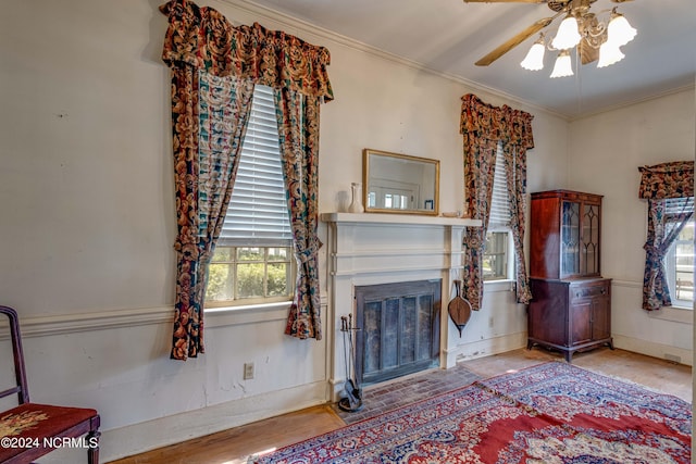 living room featuring crown molding and ceiling fan