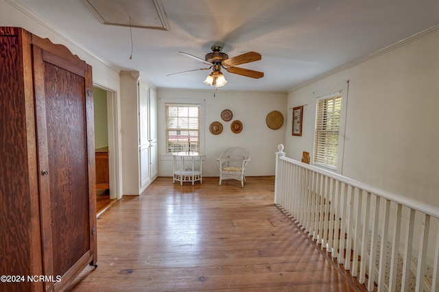 hallway featuring ornamental molding and light hardwood / wood-style flooring