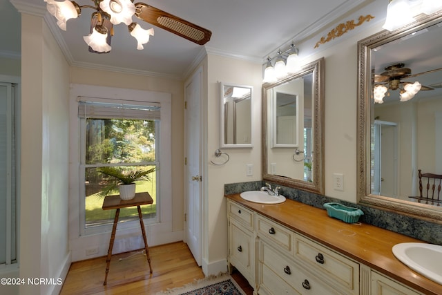 bathroom with vanity, crown molding, wood-type flooring, and ceiling fan