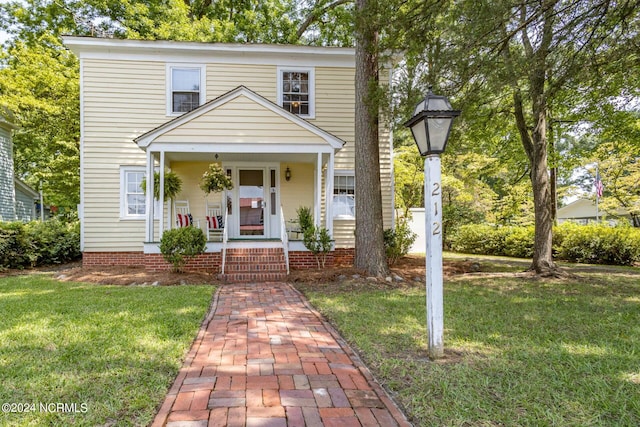 view of front of house featuring a front yard and covered porch