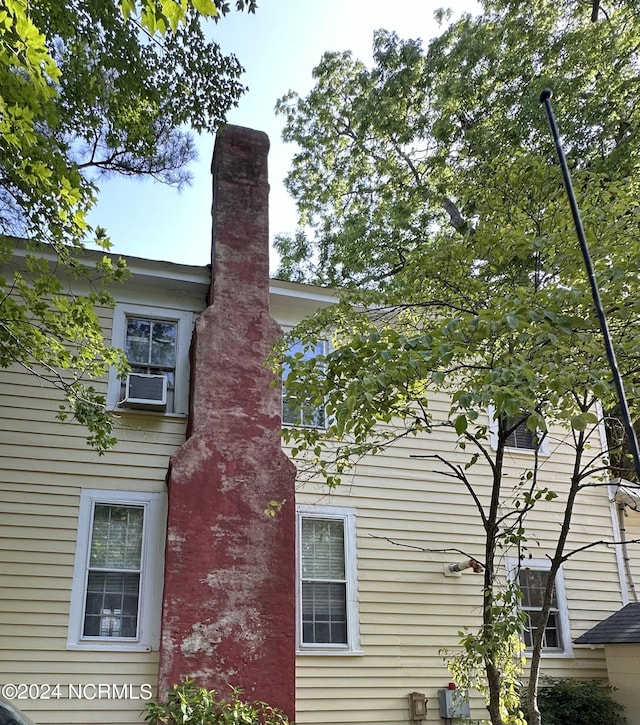 view of side of property with cooling unit