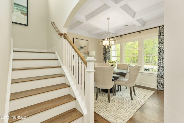 dining room featuring beamed ceiling, dark hardwood / wood-style flooring, ornamental molding, coffered ceiling, and a notable chandelier