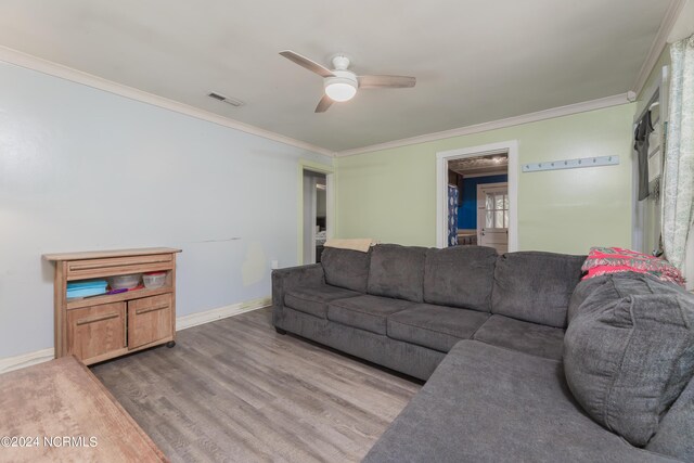 living room featuring crown molding, hardwood / wood-style flooring, and ceiling fan