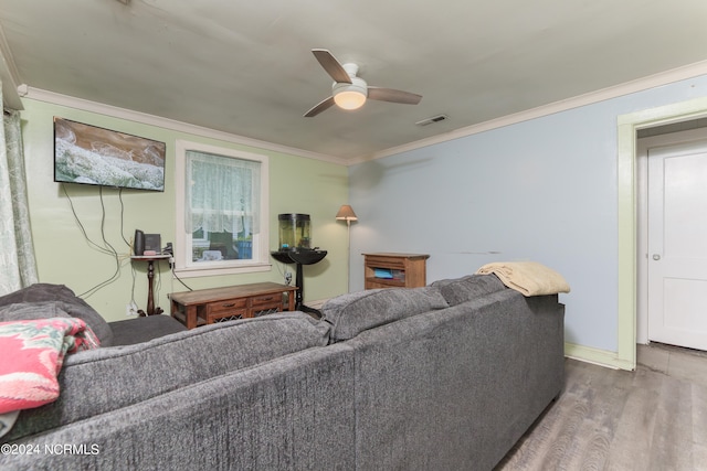 living room with hardwood / wood-style floors, ceiling fan, and ornamental molding