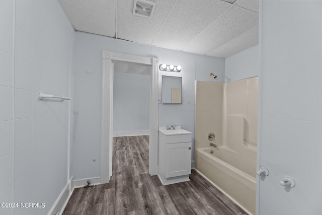 bathroom with shower / bath combination, hardwood / wood-style flooring, and vanity