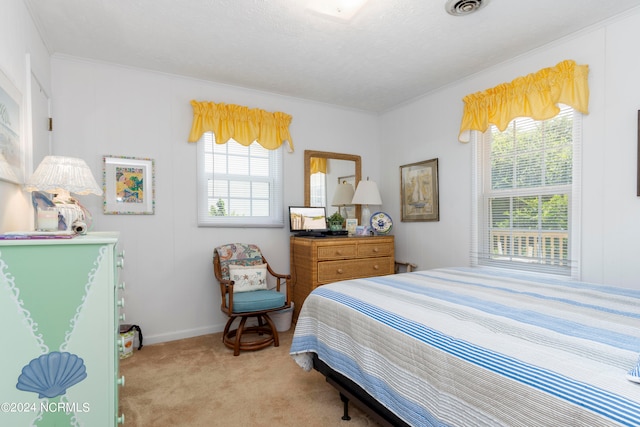 carpeted bedroom featuring crown molding