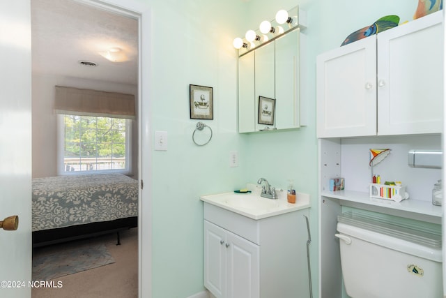 bathroom featuring vanity and toilet