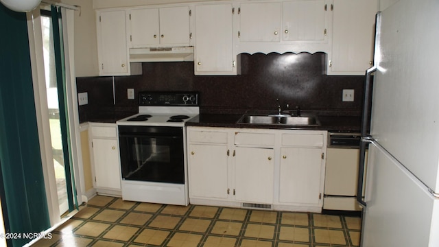 kitchen with white appliances, sink, decorative backsplash, and white cabinets