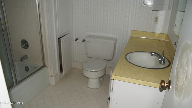 full bathroom with vanity, shower / bath combination with glass door, and toilet