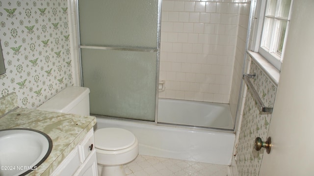 full bathroom with toilet, vanity, and shower / bath combination with glass door