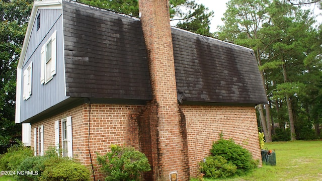 view of side of home featuring a yard