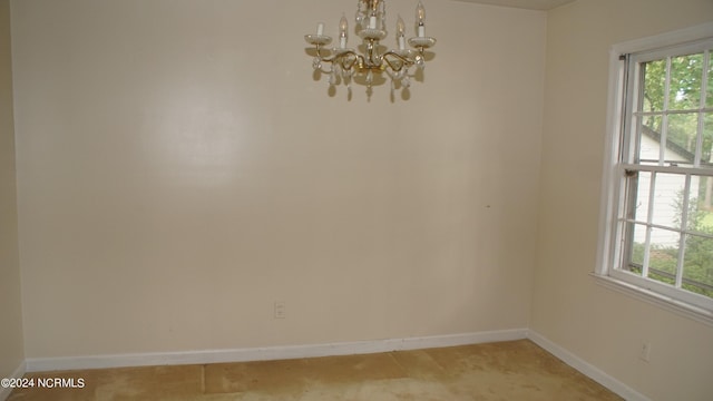 empty room with an inviting chandelier