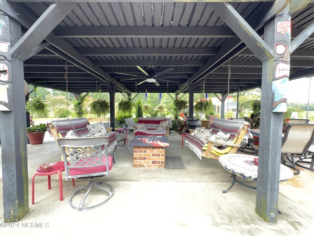 view of patio featuring an outdoor living space with a fire pit