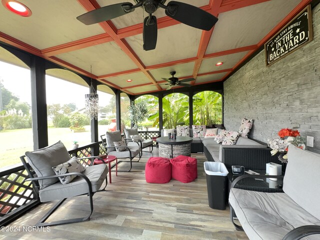 sunroom / solarium with ceiling fan and coffered ceiling