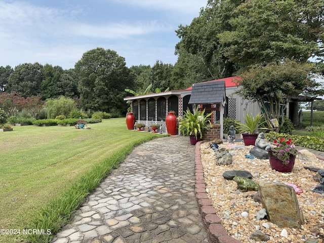 view of front of house featuring a front lawn and a sunroom