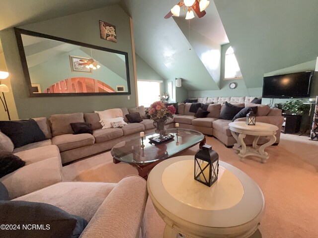 home theater room featuring ceiling fan and high vaulted ceiling