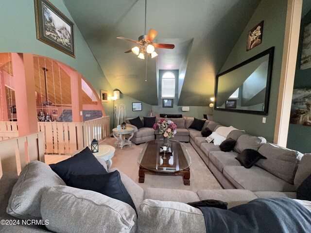 living room with ceiling fan and vaulted ceiling