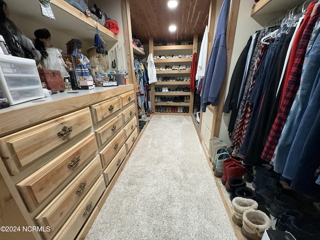 walk in closet with carpet floors