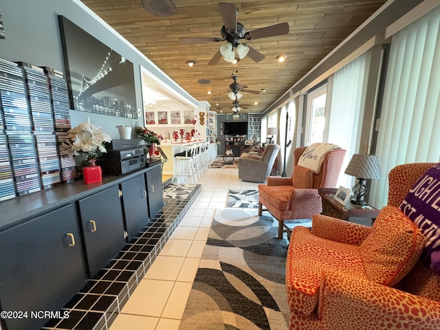 interior space with ceiling fan, wooden ceiling, and tile patterned flooring