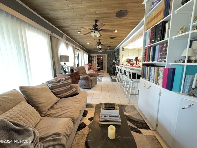 tiled living room featuring ceiling fan, wooden ceiling, and crown molding