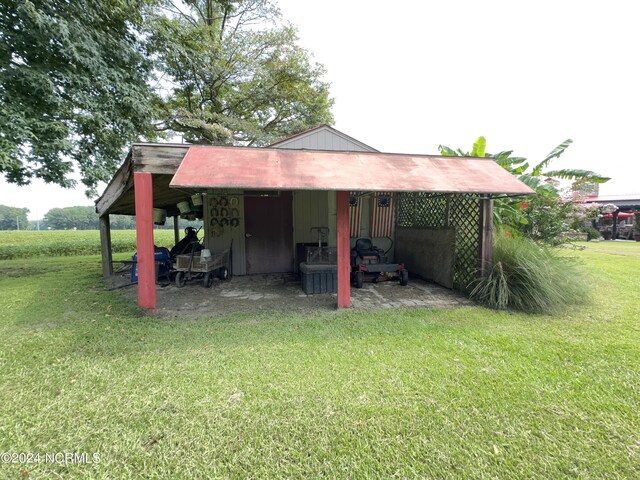 view of outbuilding with a yard