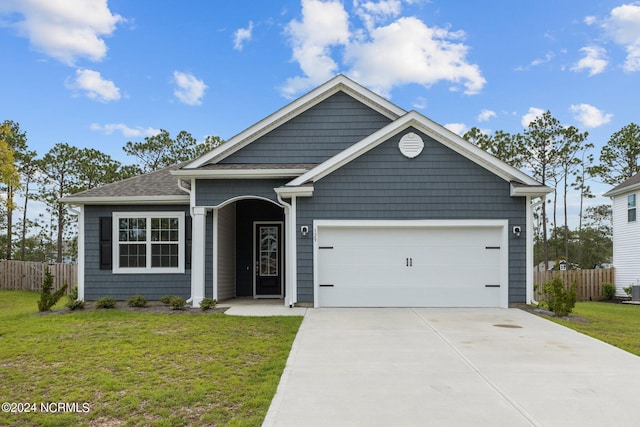 view of front of house featuring a garage and a front lawn