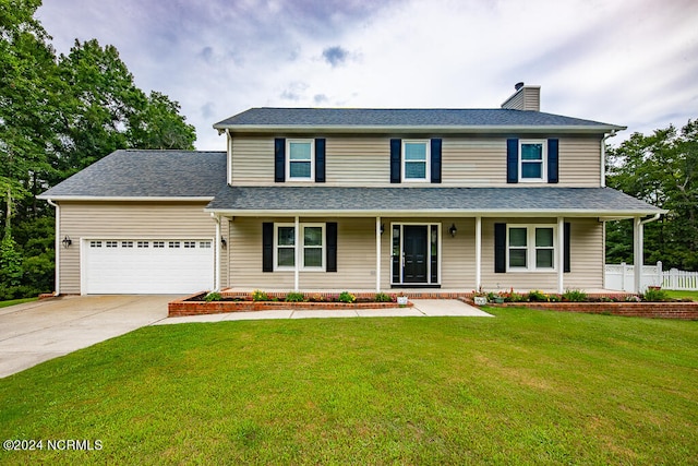 view of front of home with a garage and a front lawn