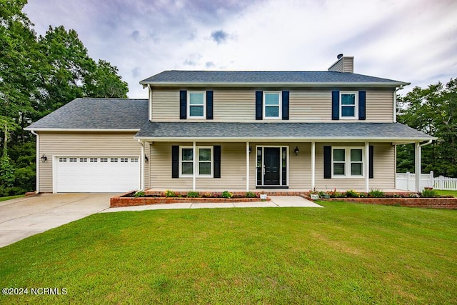 view of front of house with a garage, a front yard, and covered porch