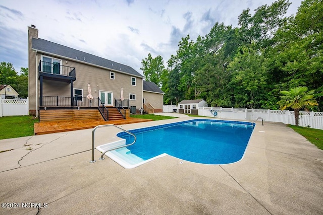 view of pool with a wooden deck, a patio area, and cooling unit