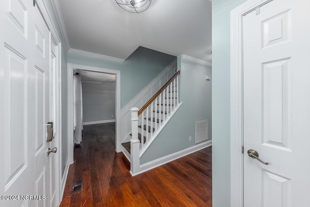 staircase with hardwood / wood-style flooring and ornamental molding