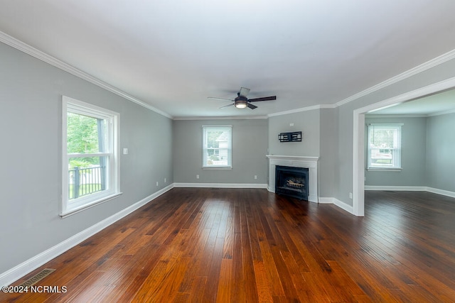 unfurnished living room featuring ceiling fan, dark hardwood / wood-style floors, and ornamental molding