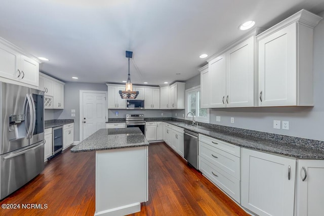 kitchen featuring a kitchen island, dark stone countertops, wine cooler, white cabinets, and stainless steel appliances