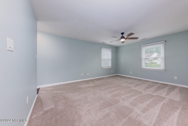 empty room featuring carpet floors and ceiling fan