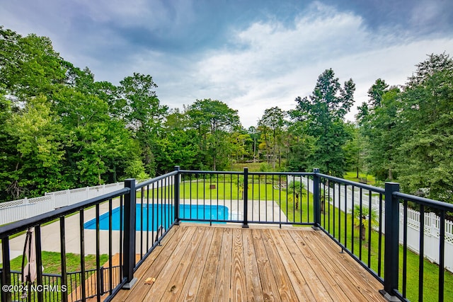 wooden terrace with a fenced in pool