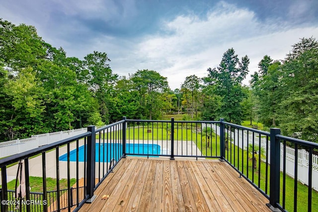 wooden deck featuring a fenced in pool