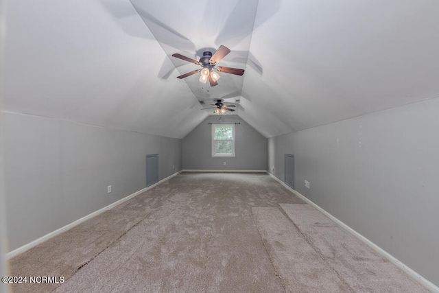 additional living space with vaulted ceiling, carpet floors, and ceiling fan