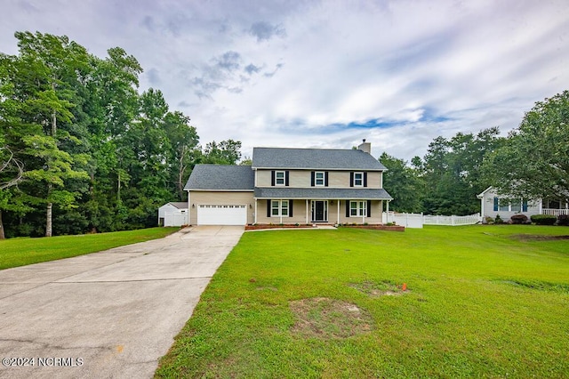 colonial house with a garage and a front lawn