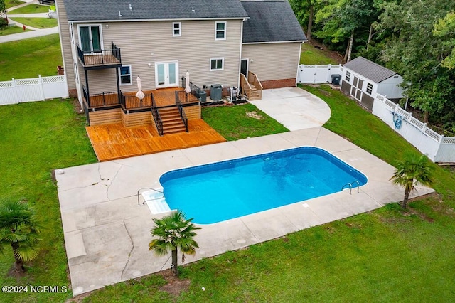 view of pool featuring a wooden deck, a yard, a patio area, and cooling unit