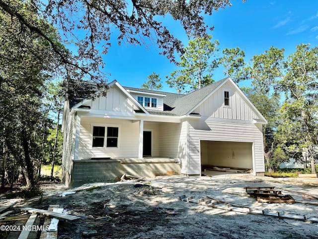 modern farmhouse style home featuring board and batten siding, roof with shingles, and a garage