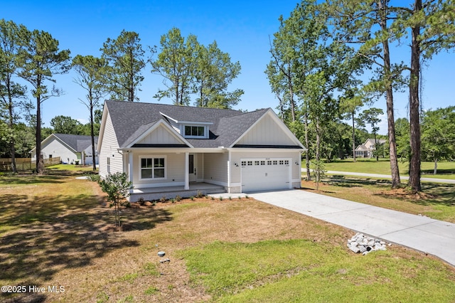 4039 Pintail Ave, Shallotte, NC 28470 - modern inspired farmhouse featuring an attached garage, covered porch, driveway, a front yard, and roof with shingles