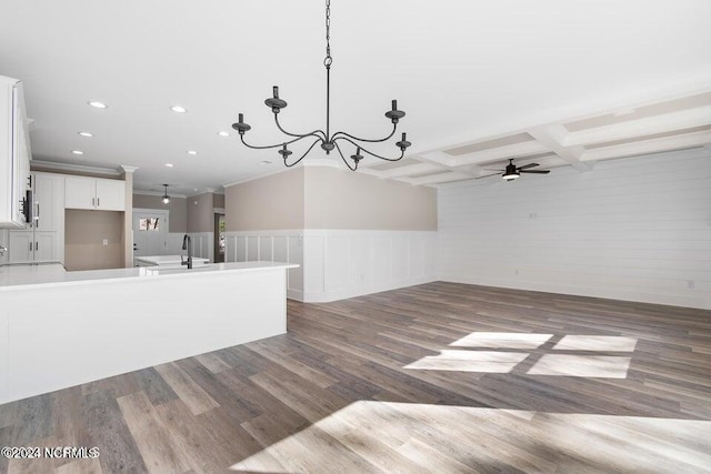 interior space with recessed lighting, coffered ceiling, wood finished floors, a sink, and beam ceiling