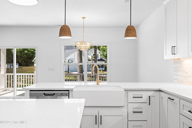 4039 Pintail Ave, Shallotte, NC 28470 - kitchen featuring plenty of natural light, tasteful backsplash, white cabinets, and light stone countertops