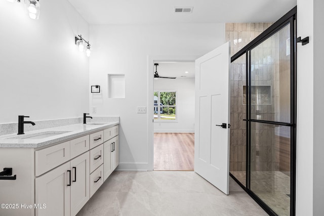 4039 Pintail Ave, Shallotte, NC 28470 - bathroom featuring double vanity, tiled shower, and a ceiling fan