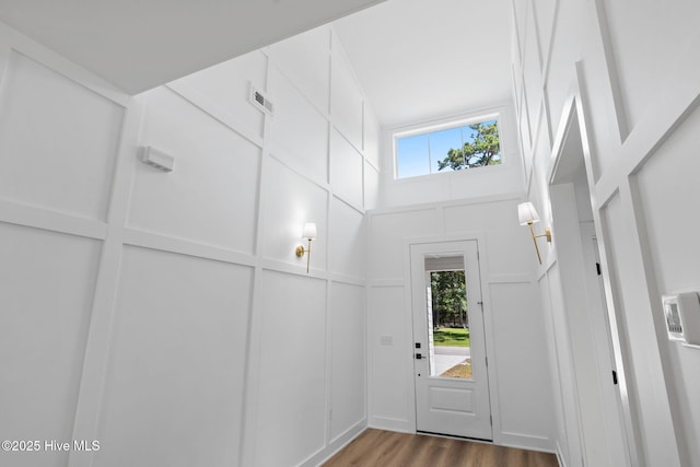 4039 Pintail Ave, Shallotte, NC 28470 - doorway to outside with wood finished floors and a towering ceiling