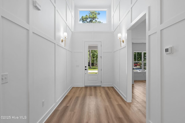 4039 Pintail Ave, Shallotte, NC 28470 - entrance foyer with light wood finished floors, plenty of natural light, a high ceiling, and a decorative wall