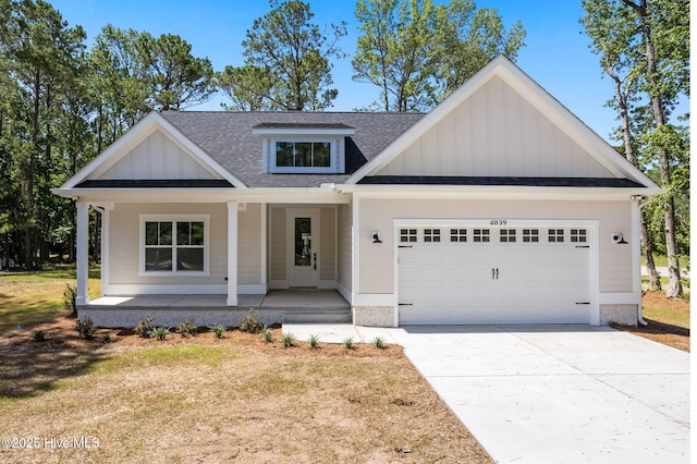 4039 Pintail Ave, Shallotte, NC 28470 - view of front of property with board and batten siding, roof with shingles, a porch, and an attached garage