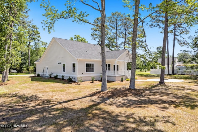 4039 Pintail Ave, Shallotte, NC 28470 - view of property exterior featuring covered porch, roof with shingles, and a lawn